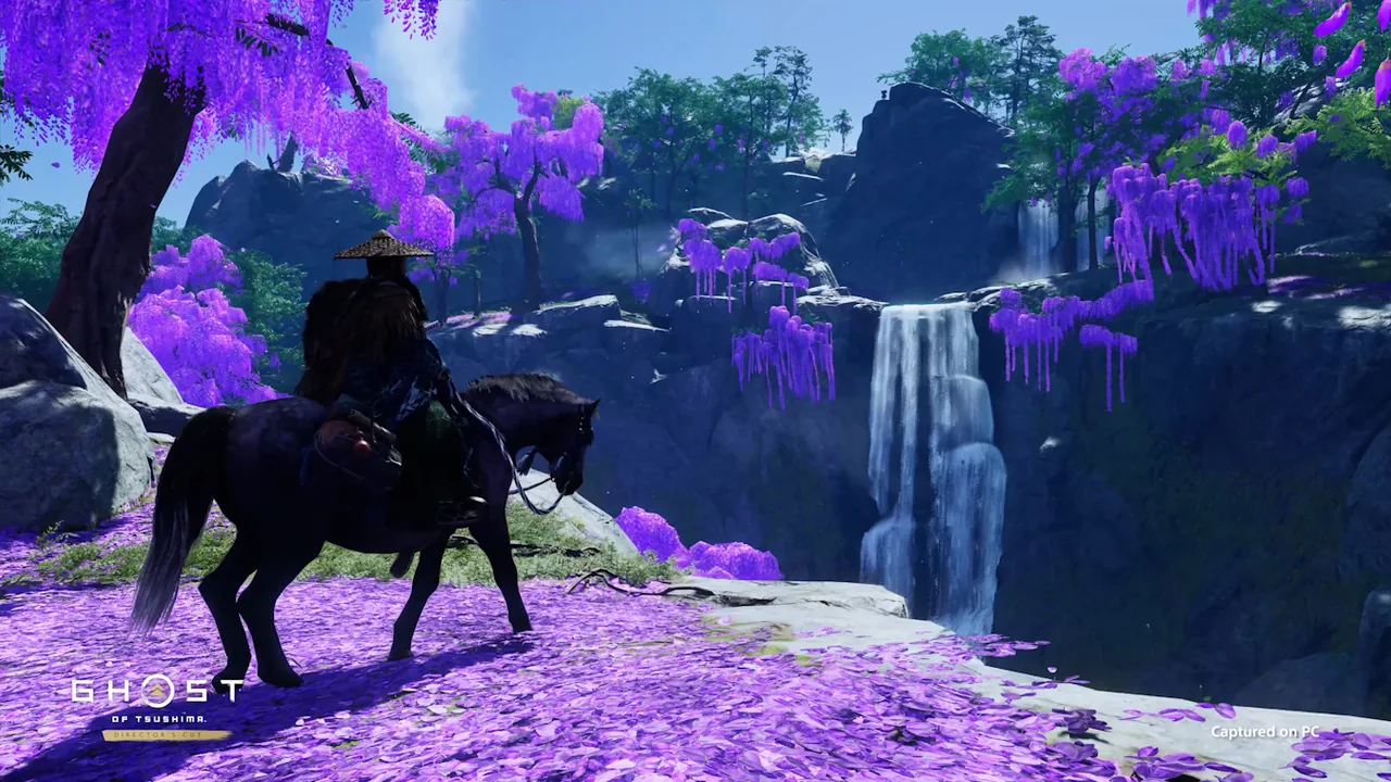 Jin Sakai riding a horse beside a waterfall in Ghost of Tsushima